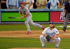 Matt Carpenter hits a double as Clayton Kershaw squats and watches, sadly.