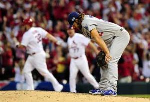 Matt Adams rounds first on a homer off Clayton Kershaw. Kershaw is sad in the foreground.